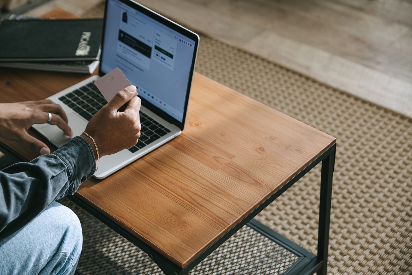 Person using a laptop and payment card