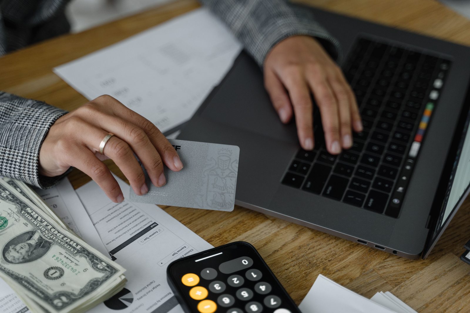 Person reviewing finances and credit information at a laptop